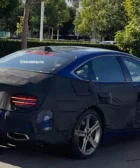 Coche camuflado con cubierta negra en la calle.