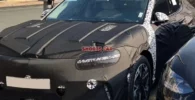 Coche camuflado posiblemente para pruebas estacionado en la calle.