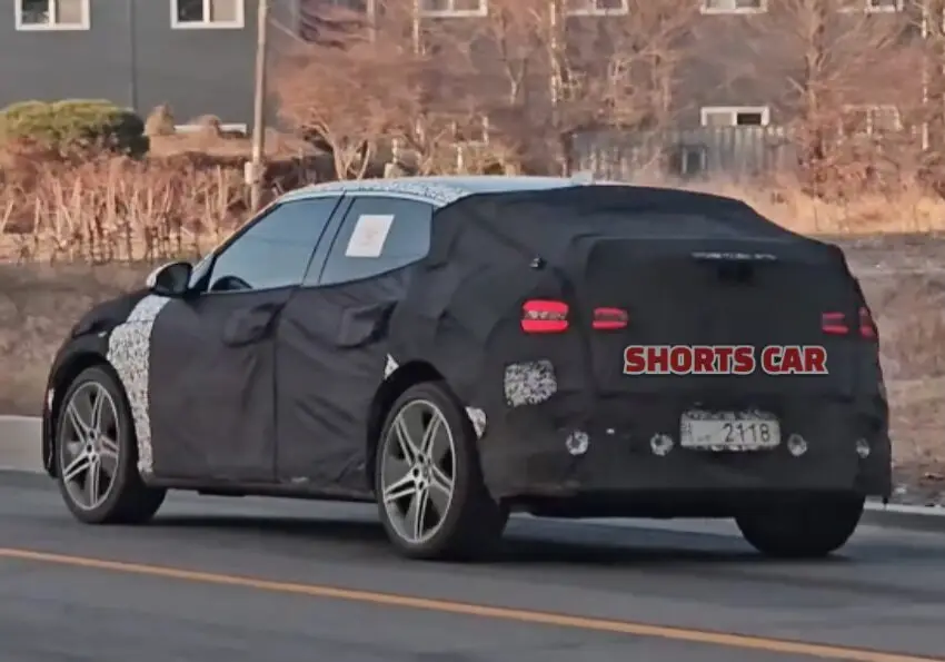 Automóvil con camuflaje de prueba en carretera.