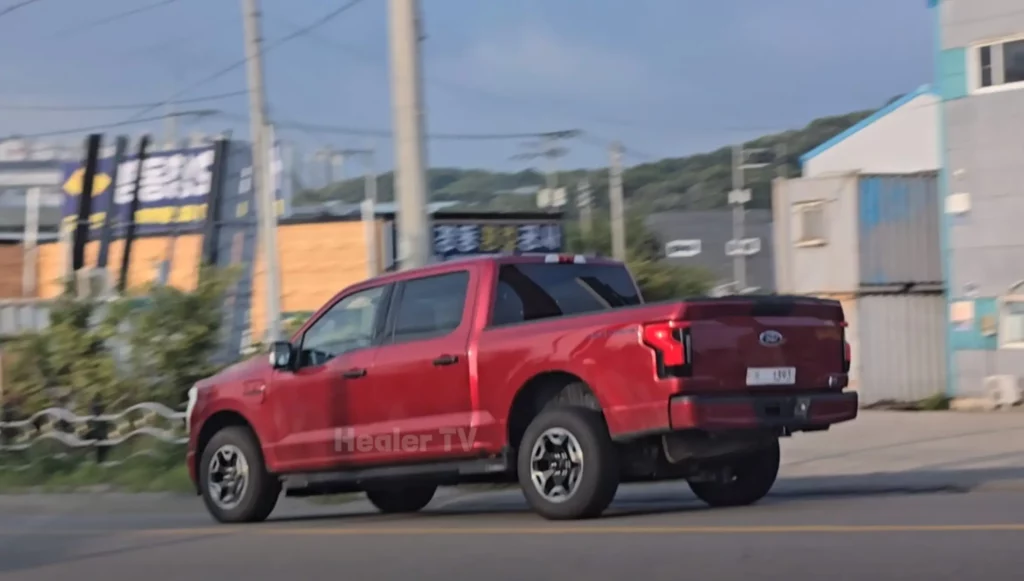 Camioneta roja Ford en una calle urbana.