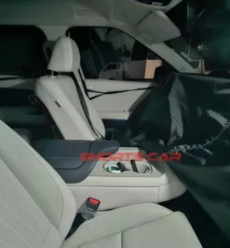 Interior de un automóvil con asientos de cuero blanco.