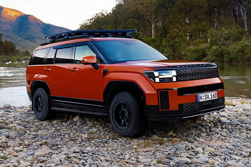 SUV naranja en entorno natural, cerca de un río y montañas.